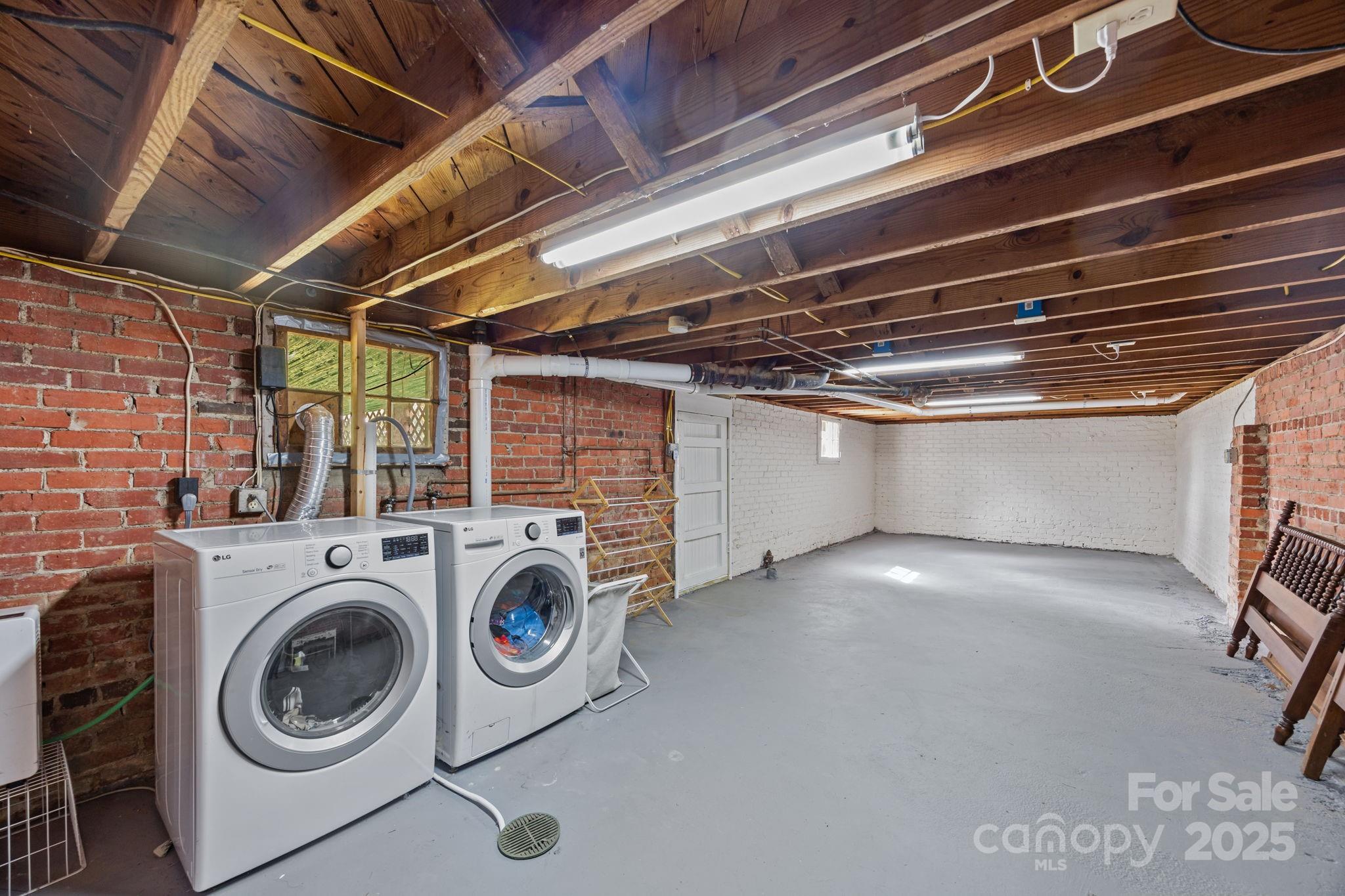 495 Fairview Road Asheville, NC 28803 - Photo 40 of 41 a view of storage and utility room with washer and dryer
