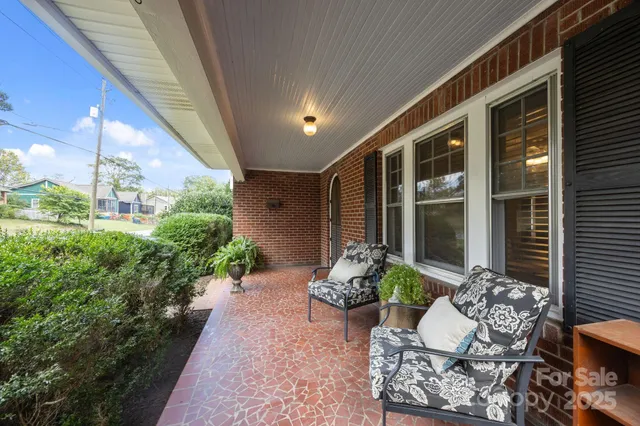 a view of a porch with chairs and a potted plant