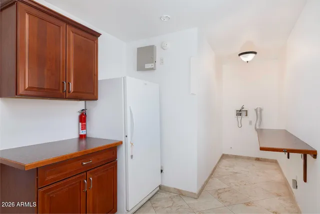 a kitchen with a refrigerator and cabinets