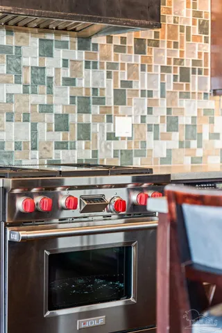 a utility room with a stove and cabinets
