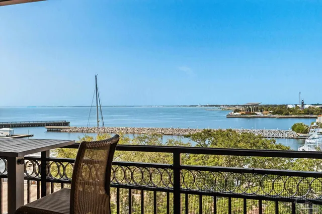a view of swimming pool with outdoor seating and city view