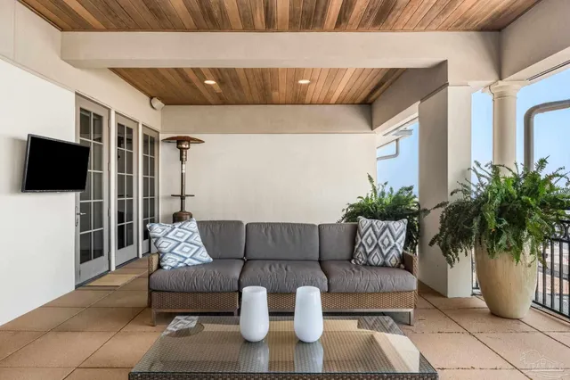a building outdoor space with patio furniture and a potted plant