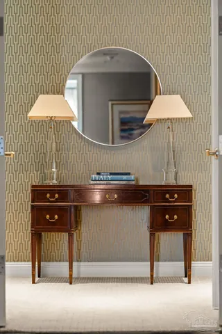 a bedroom with a bed and a large mirror