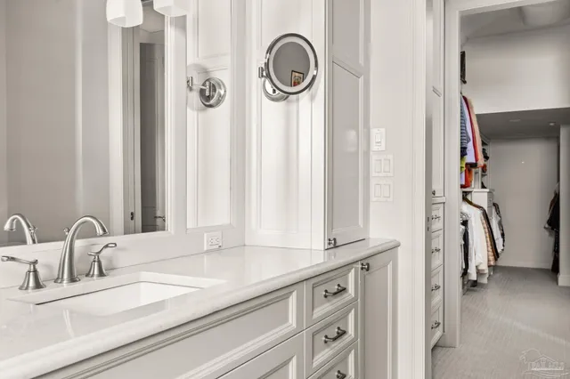 a bathroom with a granite countertop sink a mirror and a shower