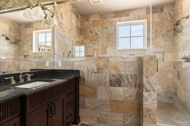 a view of walk in closet with clothes