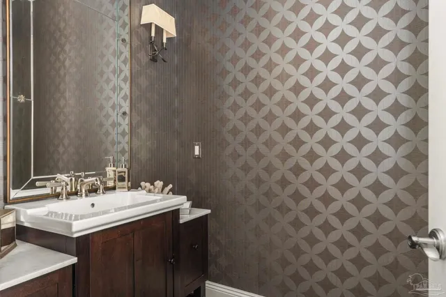 a view with granite countertop a sink a washer and dryer