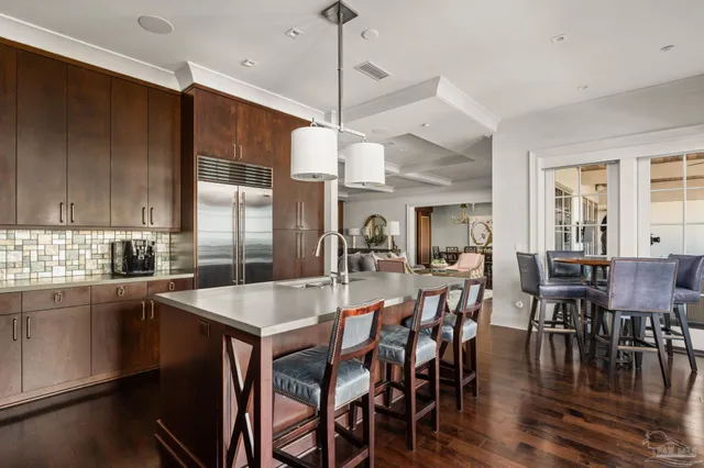 a large kitchen with kitchen island a dining table and chairs