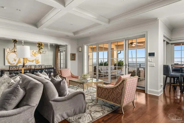 a living room with furniture and floor to ceiling windows
