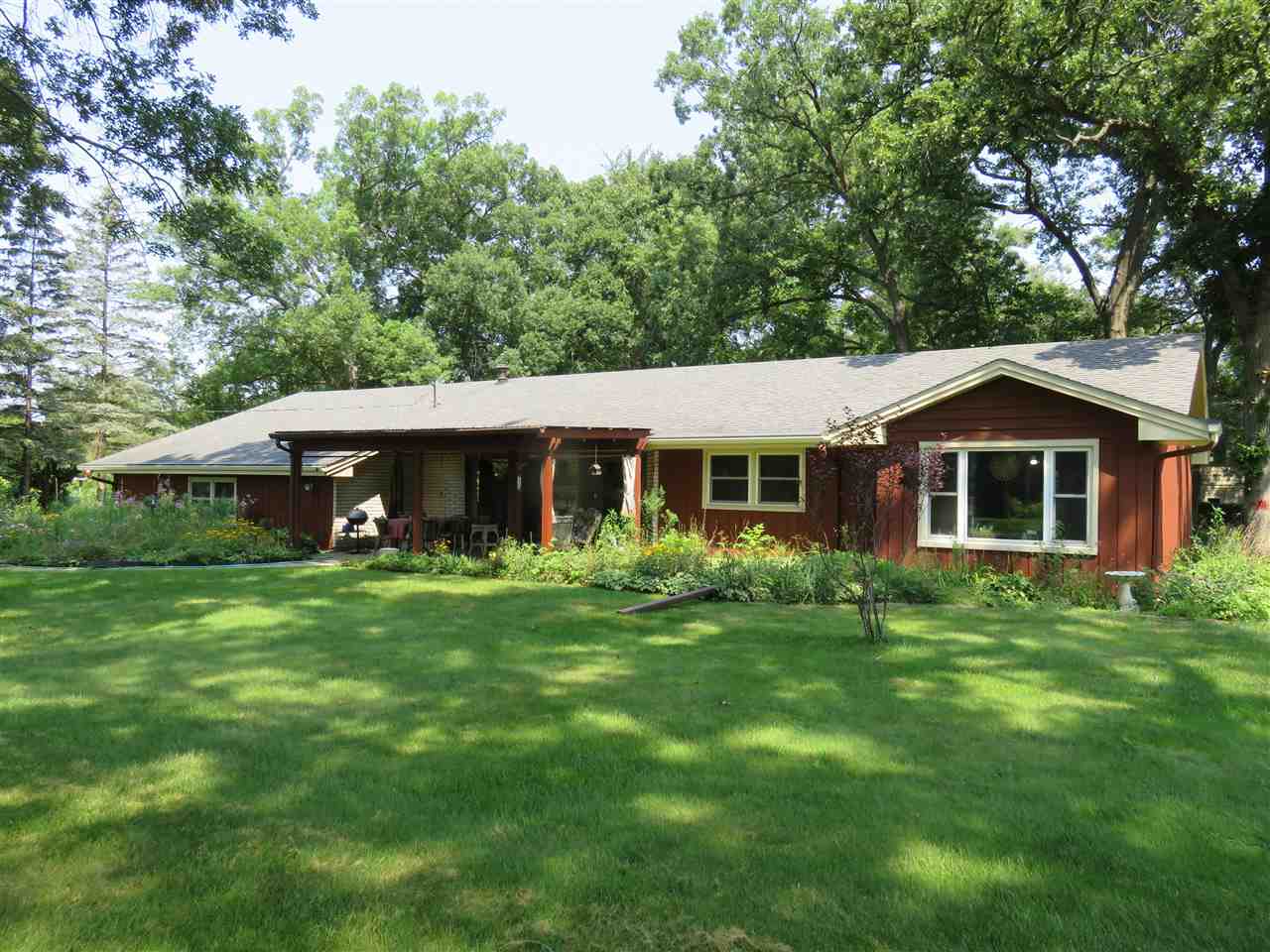 8766 Lovesee Road Roscoe, IL 61073 - Photo 1 of 27 a front view of a house with a yard porch and trees