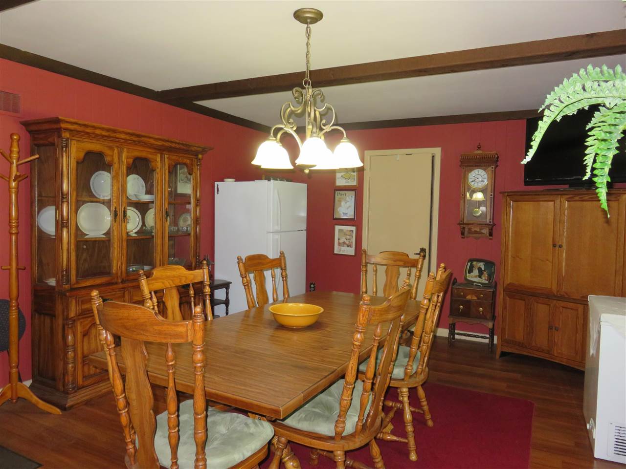 8766 Lovesee Road Roscoe, IL 61073 - Photo 14 of 27 a view of a dining room with furniture and wooden floor