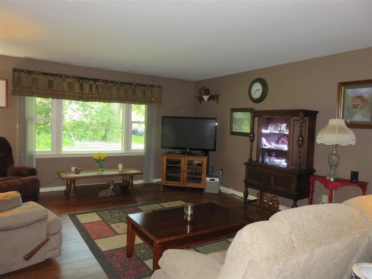 8766 Lovesee Road Roscoe, IL 61073 - Photo 17 of 27 a living room with furniture and a flat screen tv