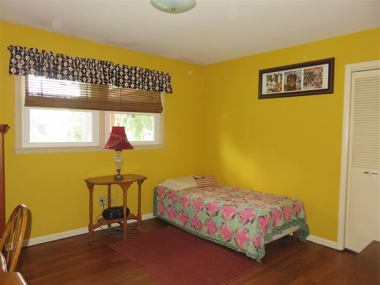 8766 Lovesee Road Roscoe, IL 61073 - Photo 18 of 27 a bedroom with a bed and wooden floor