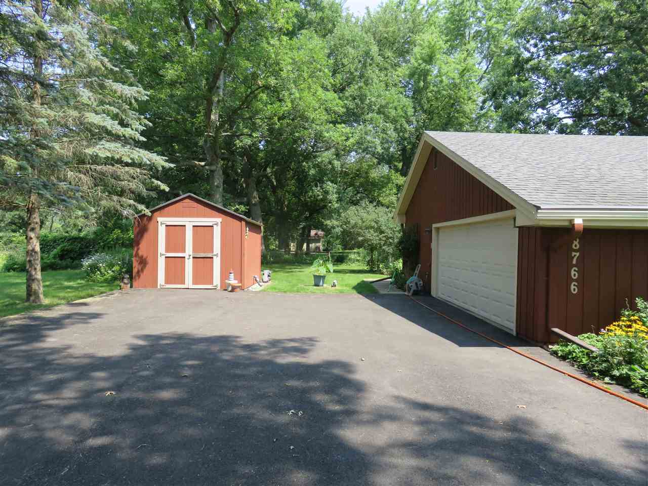 8766 Lovesee Road Roscoe, IL 61073 - Photo 2 of 27 a front view of a house with a yard and garage