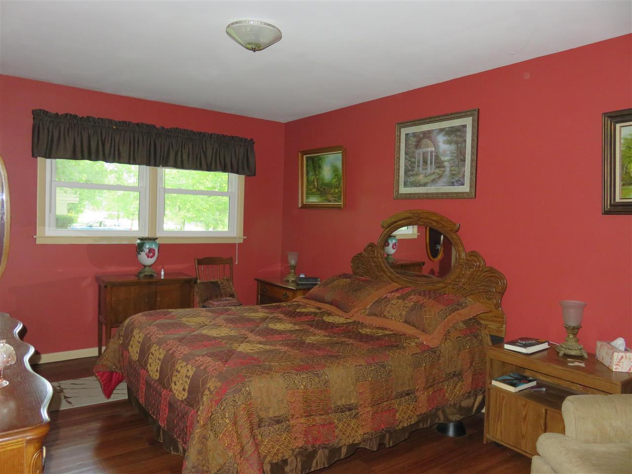 8766 Lovesee Road Roscoe, IL 61073 - Photo 25 of 27 a bedroom with a bed and wooden floor