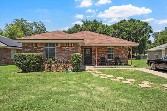 a view of a house with a yard and sitting area