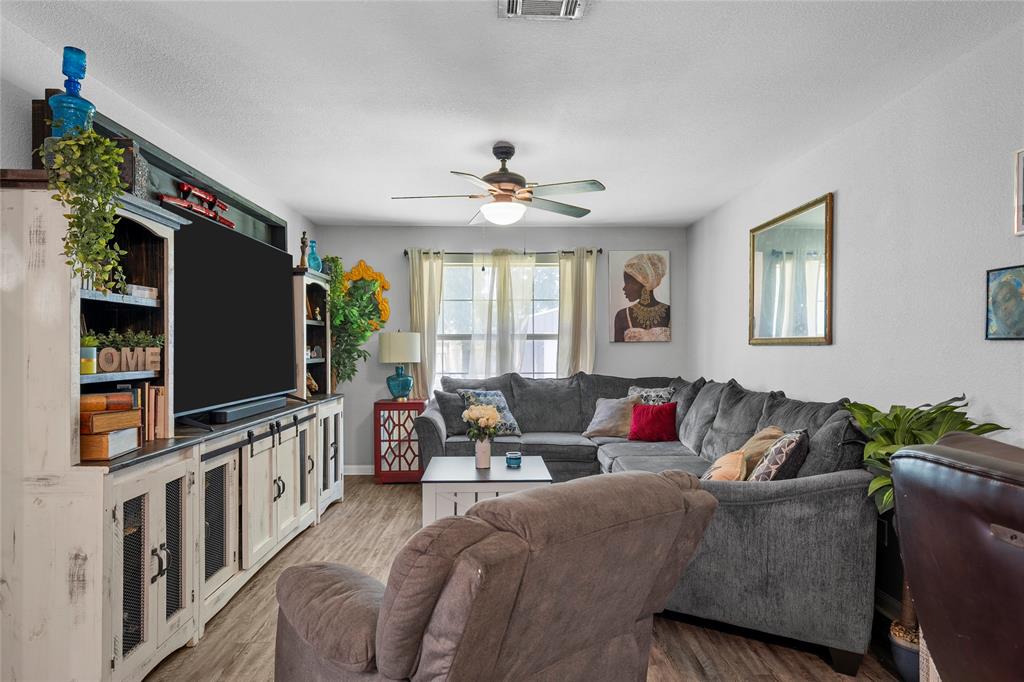 1108 Spring Street Waco, TX 76704 - Photo 3 of 17 a living room with furniture and a flat screen tv