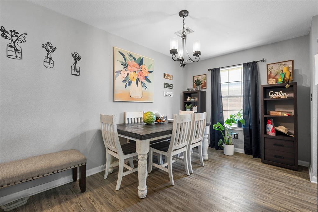 1108 Spring Street Waco, TX 76704 - Photo 5 of 17 a view of a dining room with furniture wooden floor and chandelier