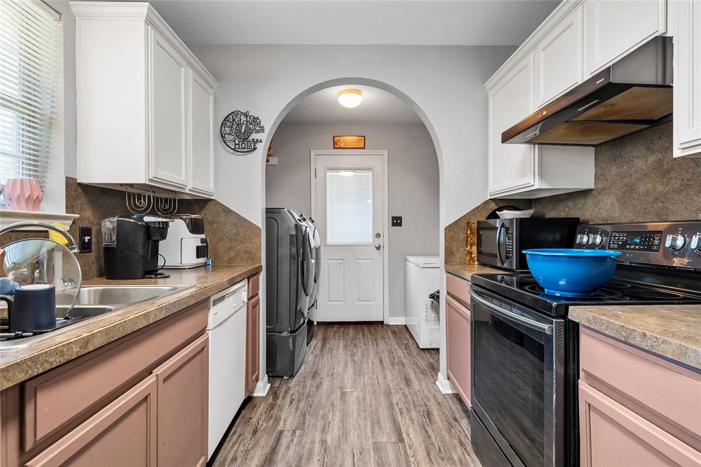 1108 Spring Street Waco, TX 76704 - Photo 6 of 17 a kitchen with granite countertop a sink a counter space appliances and cabinets