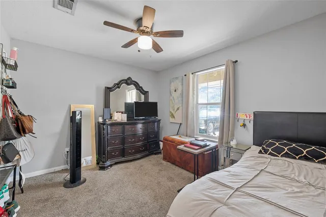 a bedroom with furniture a bed and a flat screen tv