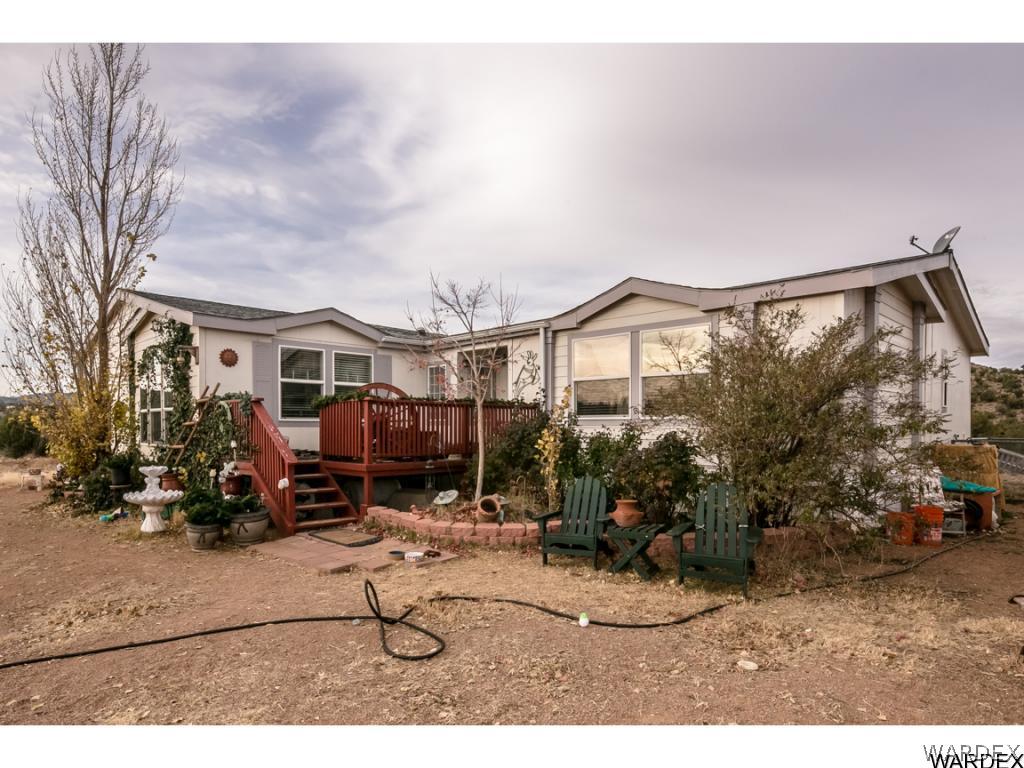 9701 East Blake Ranch Road Kingman, AZ 86401 - Photo 1 of 36 a backyard of a house with barbeque oven table and chairs