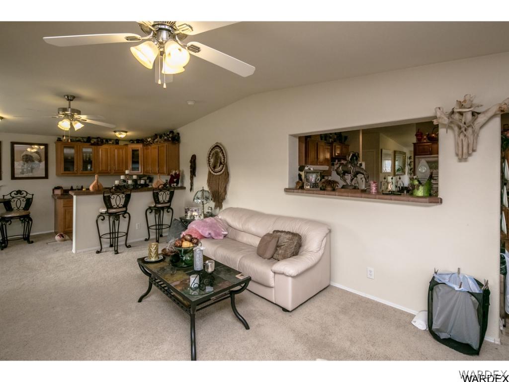9701 East Blake Ranch Road Kingman, AZ 86401 - Photo 26 of 36 a living room with furniture and a chandelier