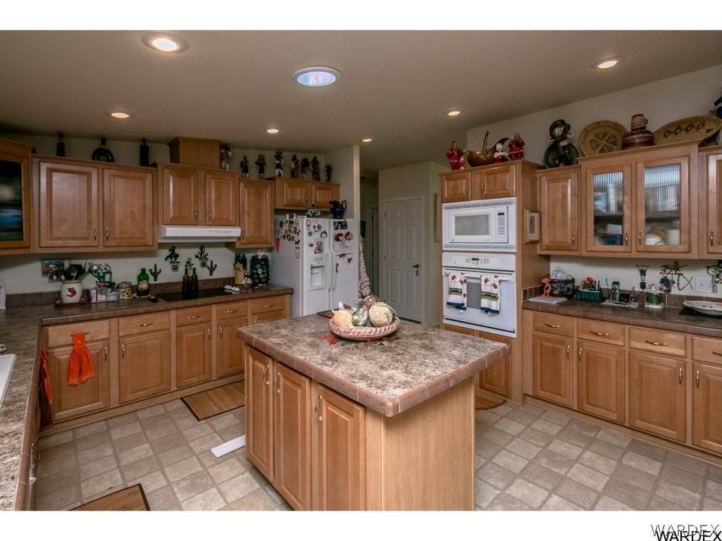 9701 East Blake Ranch Road Kingman, AZ 86401 - Photo 4 of 36 a kitchen with stainless steel appliances granite countertop a sink stove and refrigerator