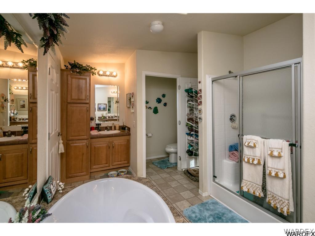 9701 East Blake Ranch Road Kingman, AZ 86401 - Photo 6 of 36 a bathroom with a sink a mirror and a shower