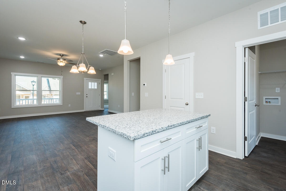 555 Pinnix Road Burlington, NC 27217 - Photo 11 of 20 a view of a kitchen island a chandelier and wooden floor