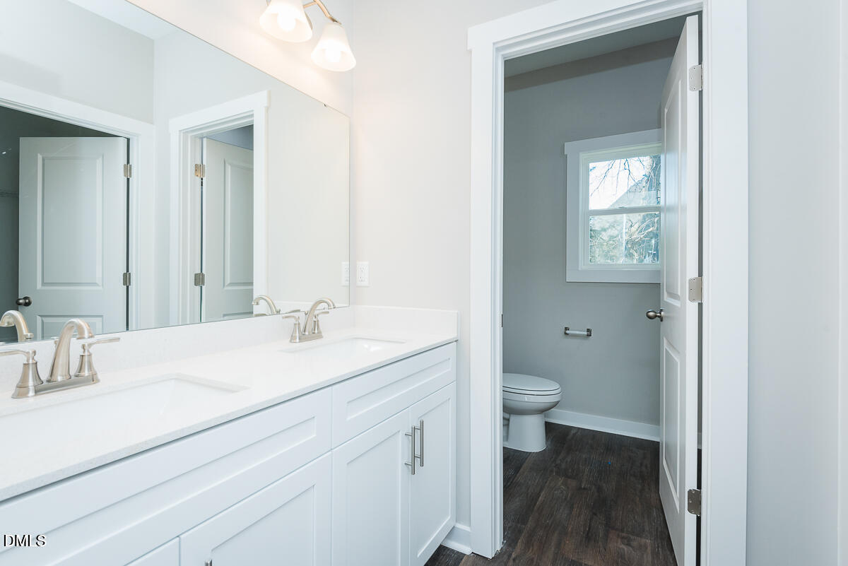 555 Pinnix Road Burlington, NC 27217 - Photo 13 of 20 a bathroom with a granite countertop sink toilet and mirror
