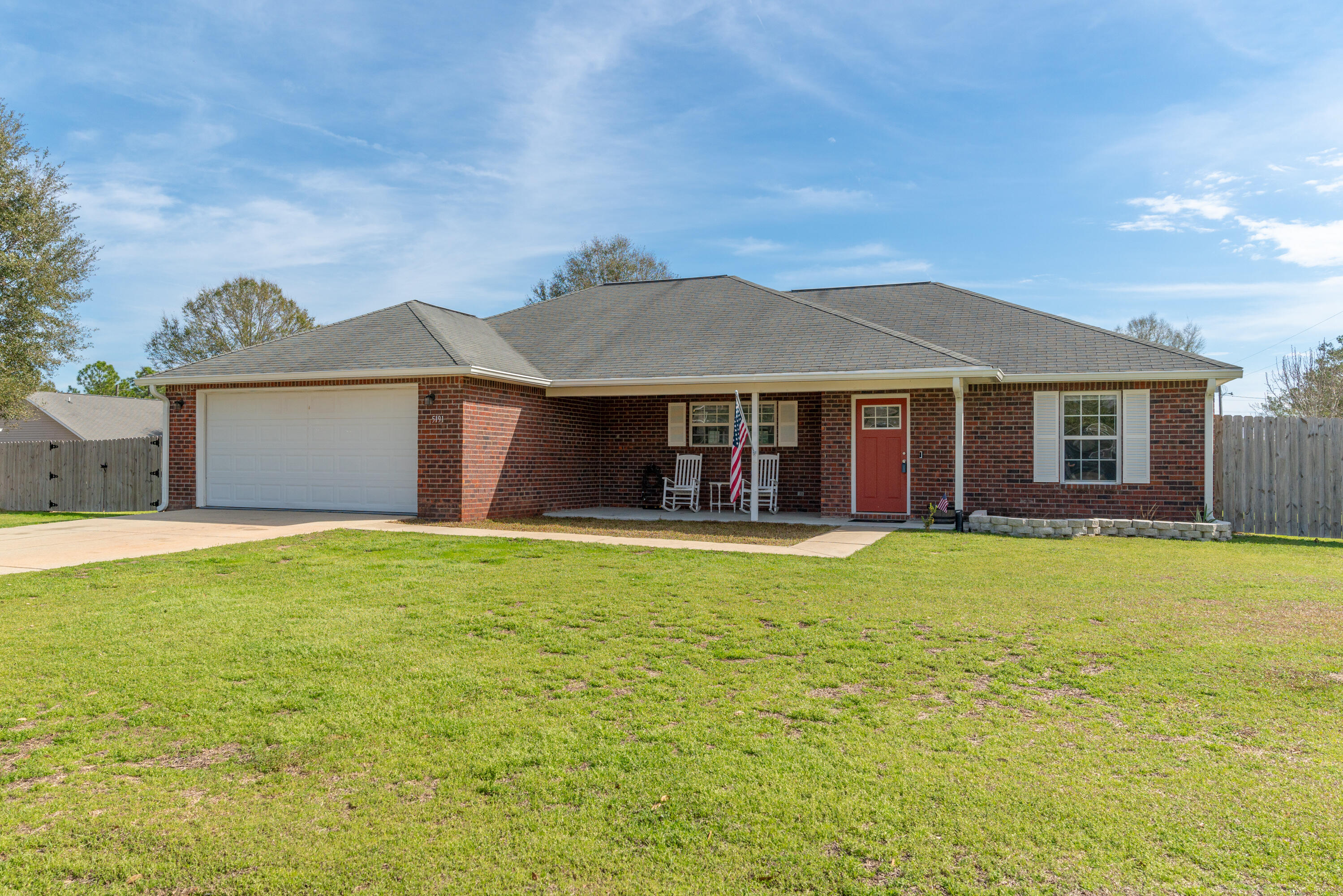 5191 Quince Avenue Crestview, FL 32539 - Photo 1 of 45 a front view of a house with a garden