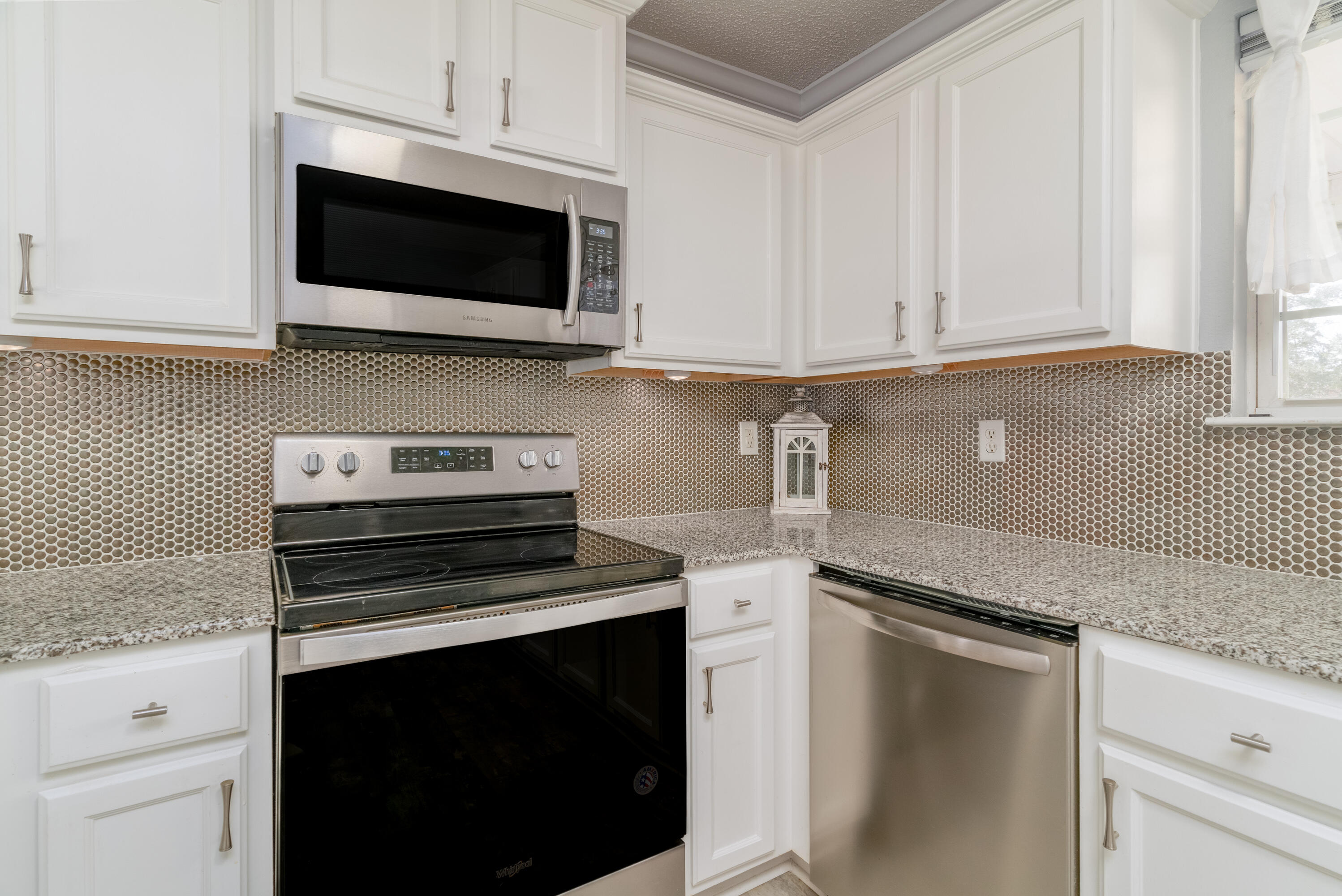 5191 Quince Avenue Crestview, FL 32539 - Photo 11 of 45 a kitchen with stainless steel appliances granite countertop a stove microwave and oven