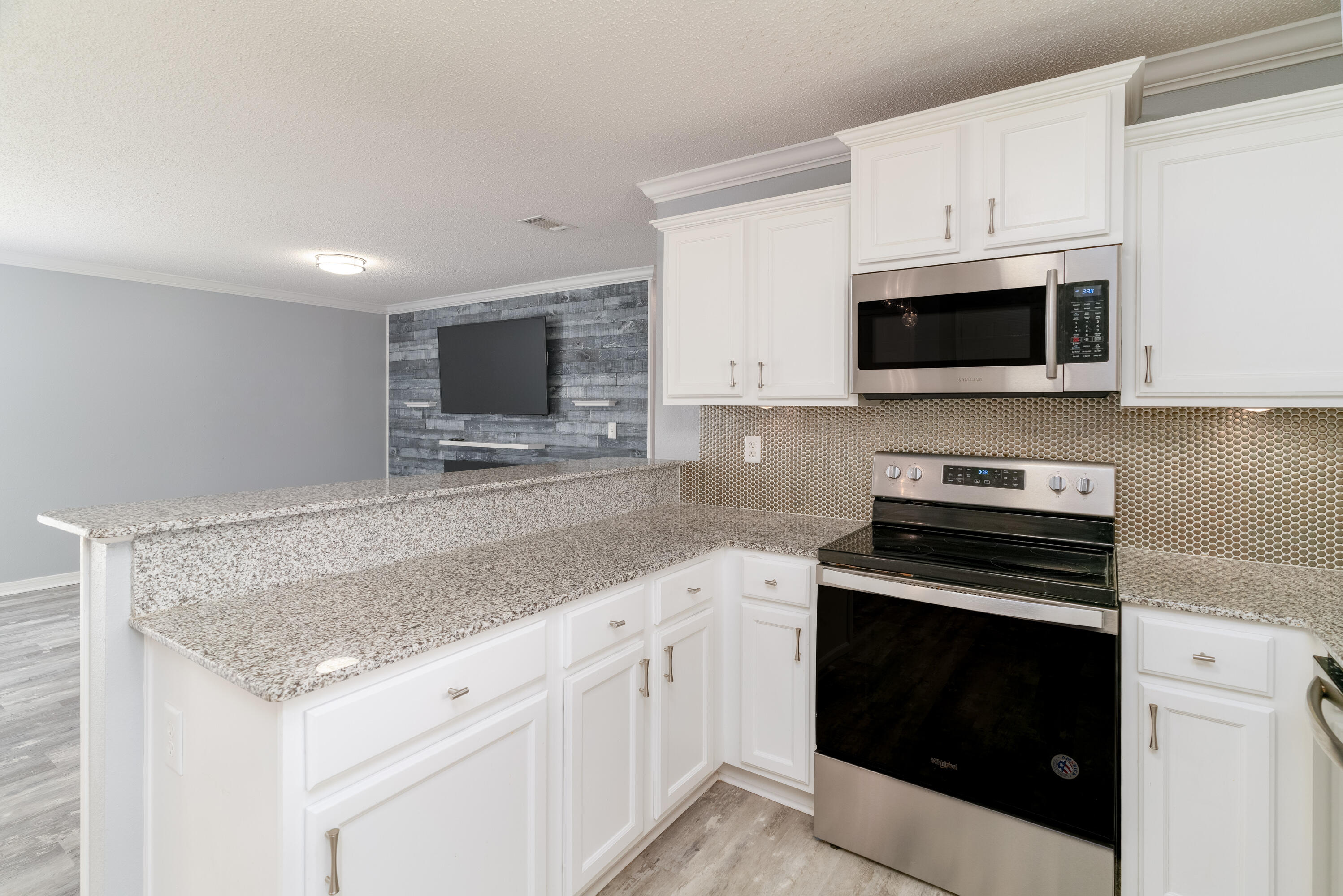 5191 Quince Avenue Crestview, FL 32539 - Photo 13 of 45 a kitchen with granite countertop a stove microwave and sink