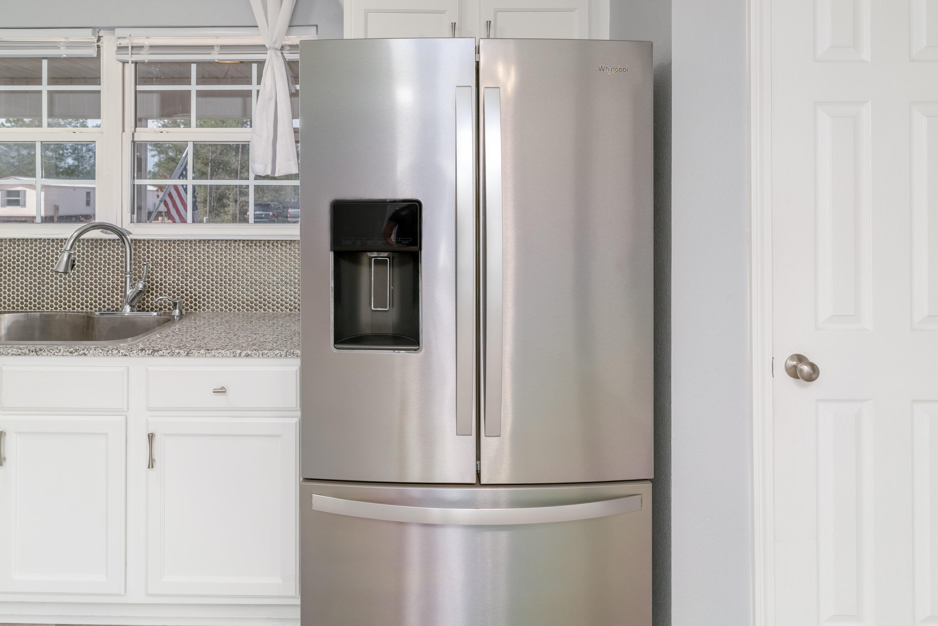 5191 Quince Avenue Crestview, FL 32539 - Photo 14 of 45 a kitchen with refrigerator and window