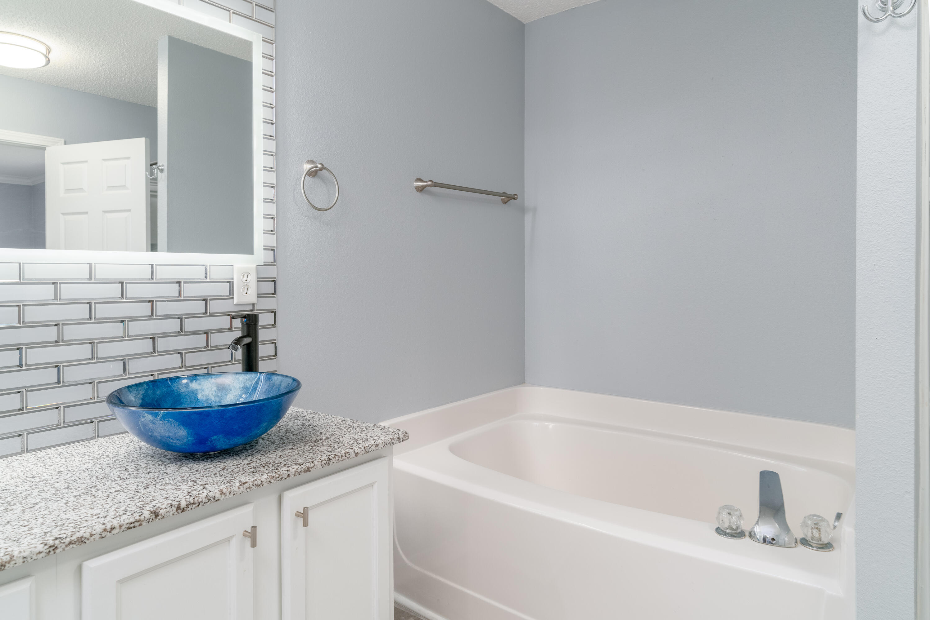 5191 Quince Avenue Crestview, FL 32539 - Photo 22 of 45 a bathroom with a granite countertop sink a toilet and a mirror
