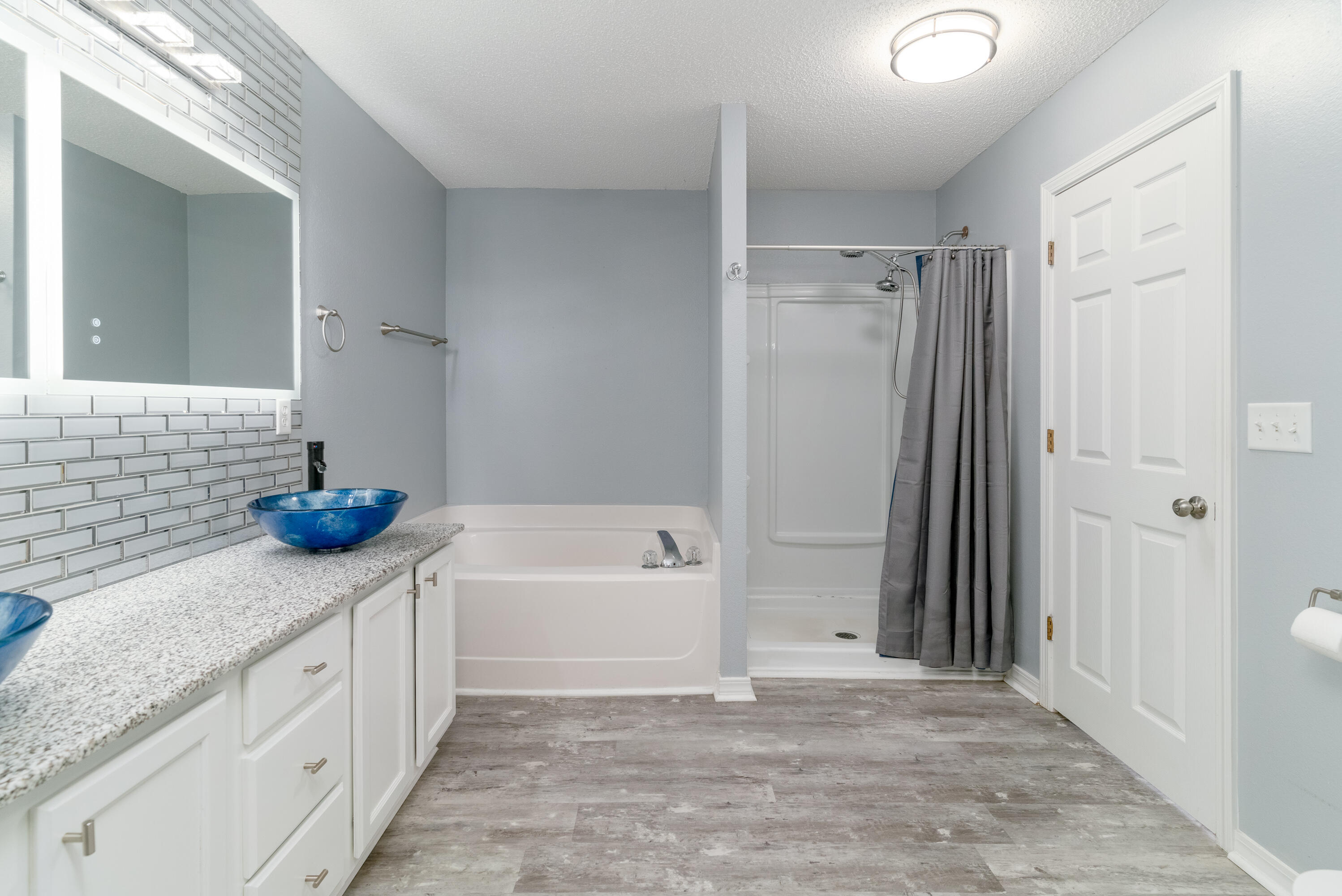 5191 Quince Avenue Crestview, FL 32539 - Photo 23 of 45 a bathroom with a tub sink and a mirror