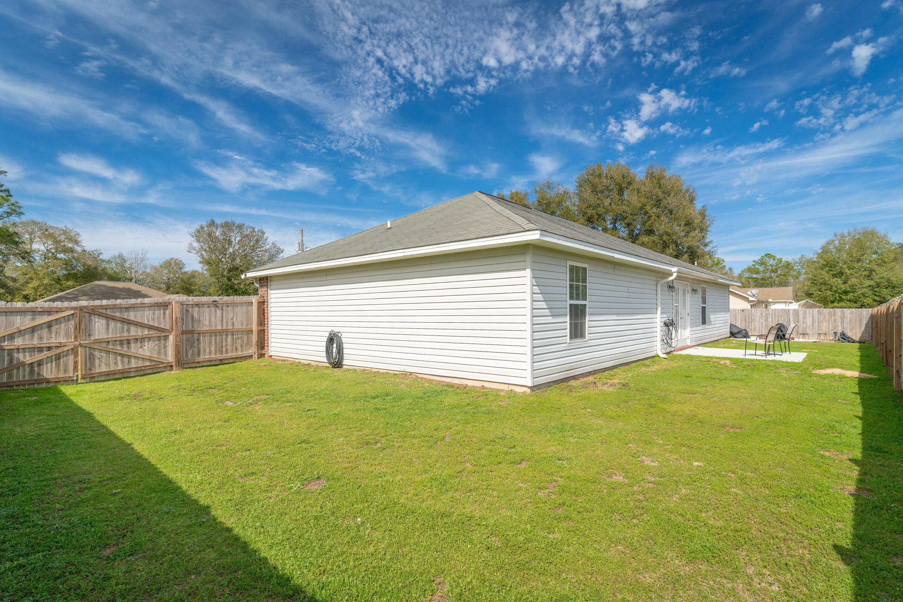 5191 Quince Avenue Crestview, FL 32539 - Photo 36 of 45 a backyard of a house with table and chairs