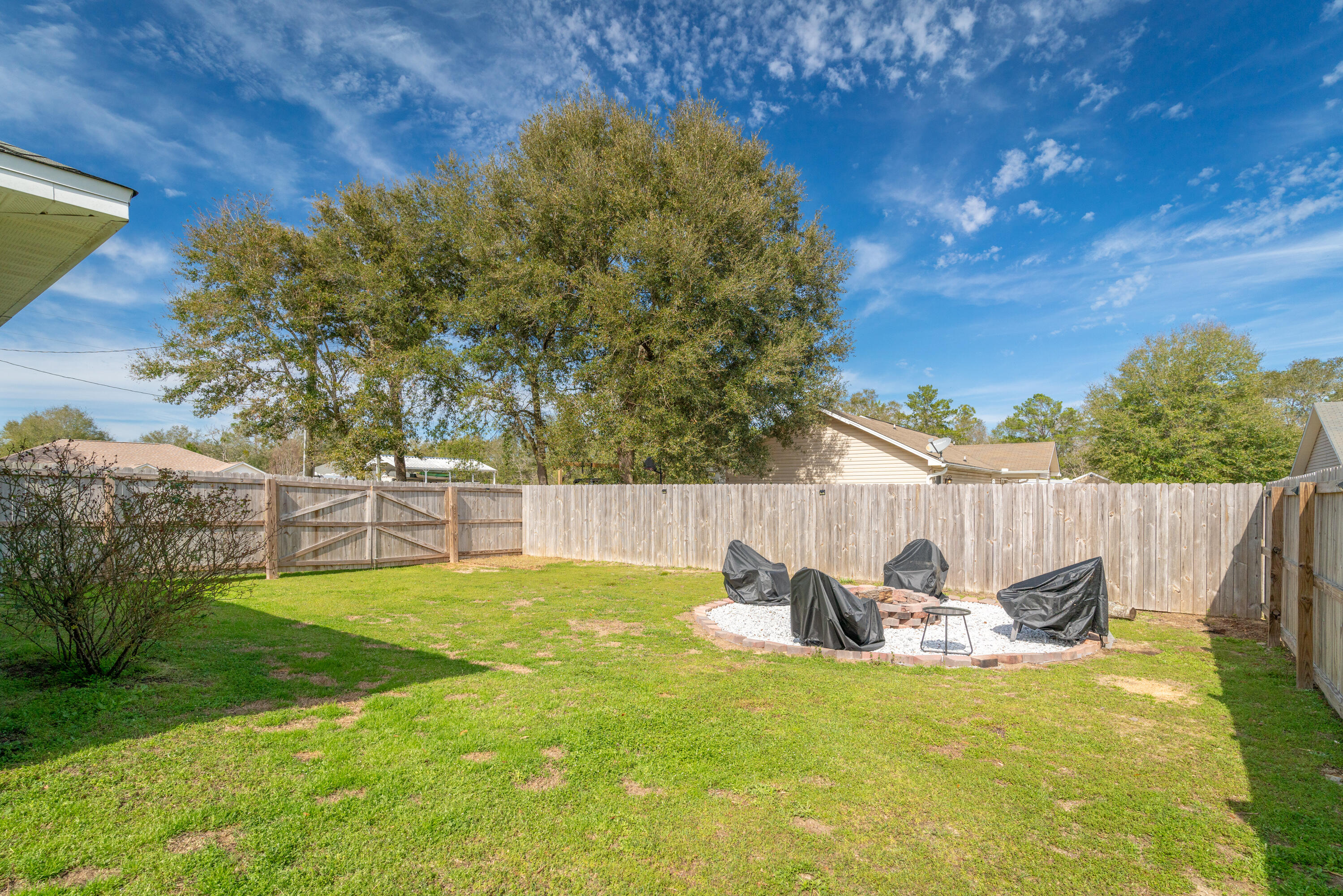 5191 Quince Avenue Crestview, FL 32539 - Photo 39 of 45 a view of a backyard with table and chairs and potted plants