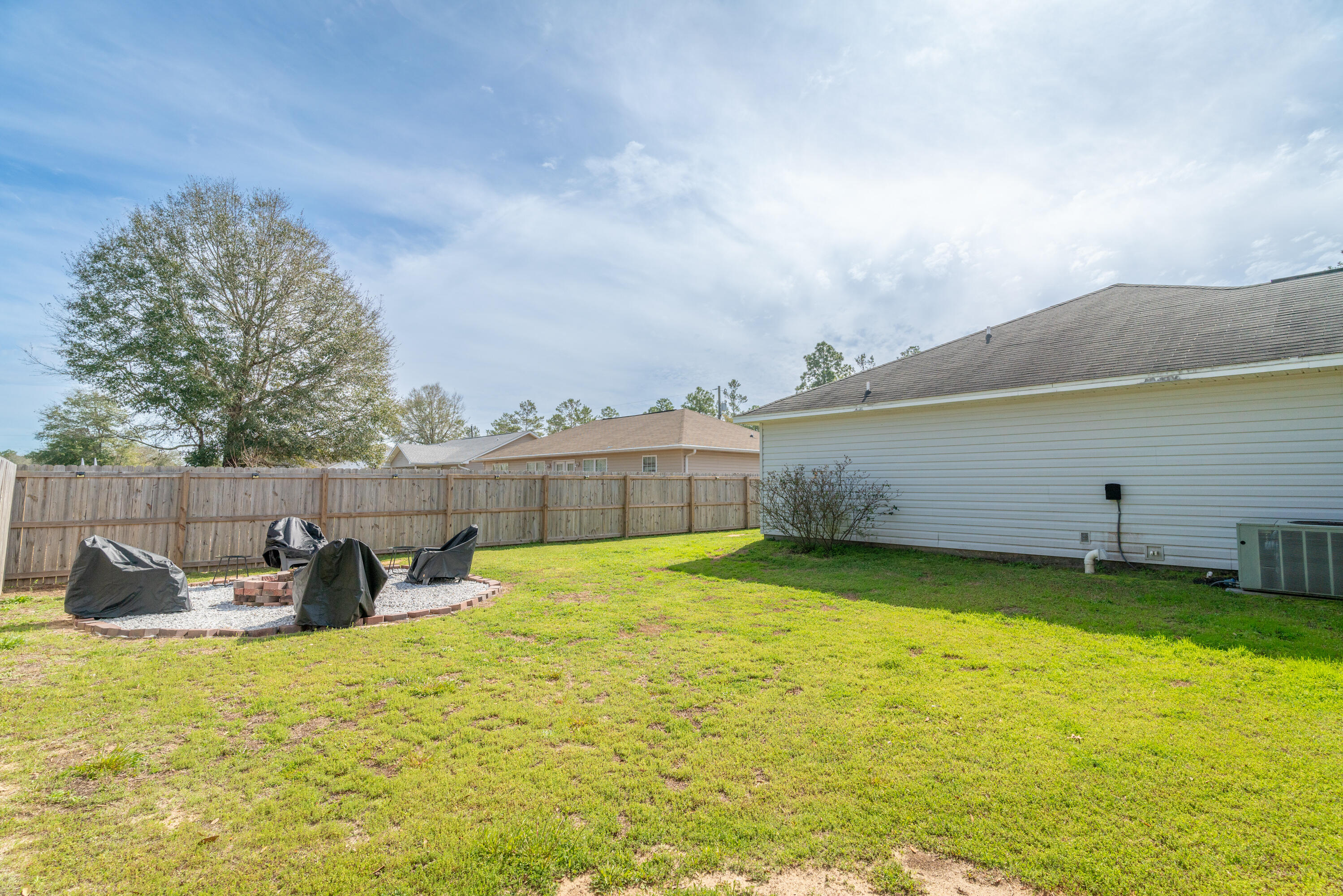 5191 Quince Avenue Crestview, FL 32539 - Photo 42 of 45 a view of a swimming pool with a lounge chairs