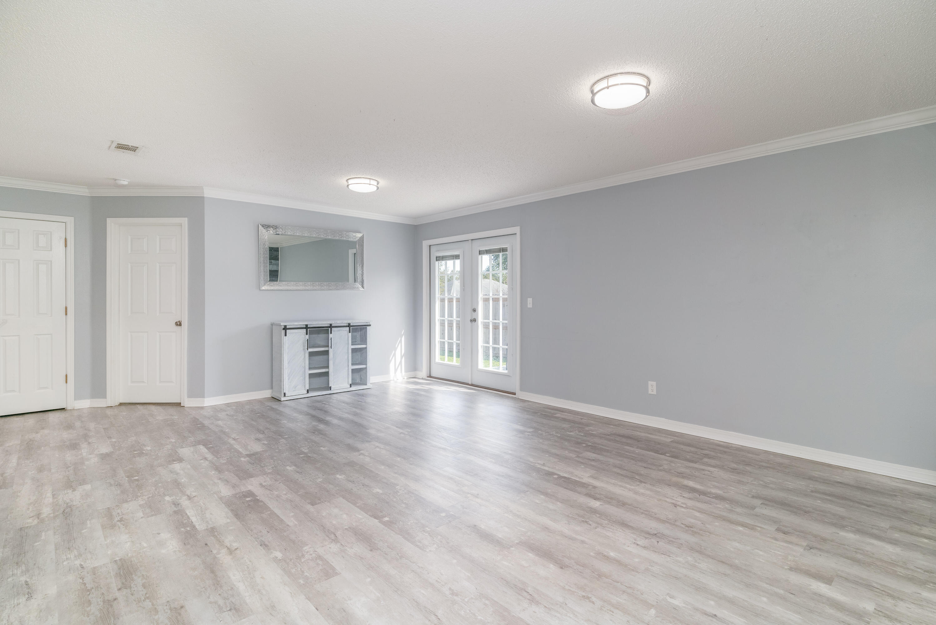 5191 Quince Avenue Crestview, FL 32539 - Photo 6 of 45 a view of empty room with wooden floor and fireplace