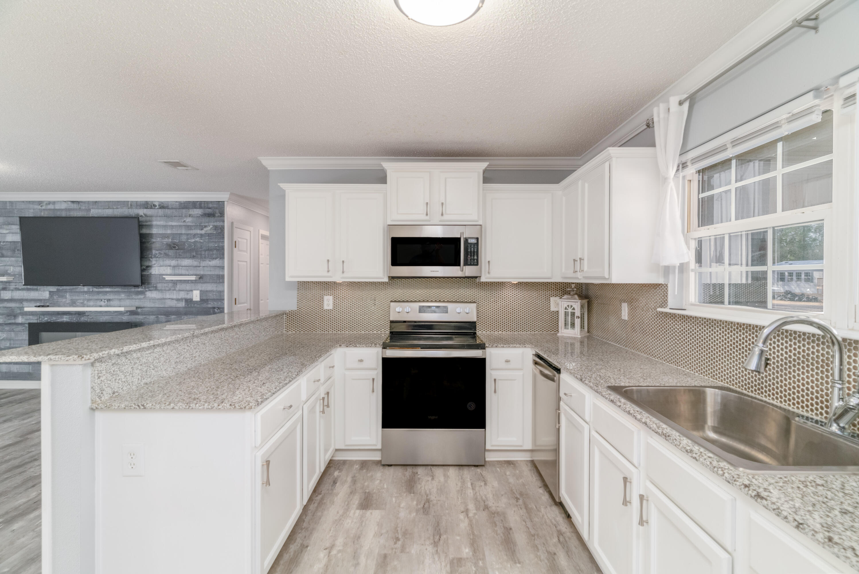 5191 Quince Avenue Crestview, FL 32539 - Photo 7 of 45 a kitchen with stainless steel appliances granite countertop a stove microwave and sink