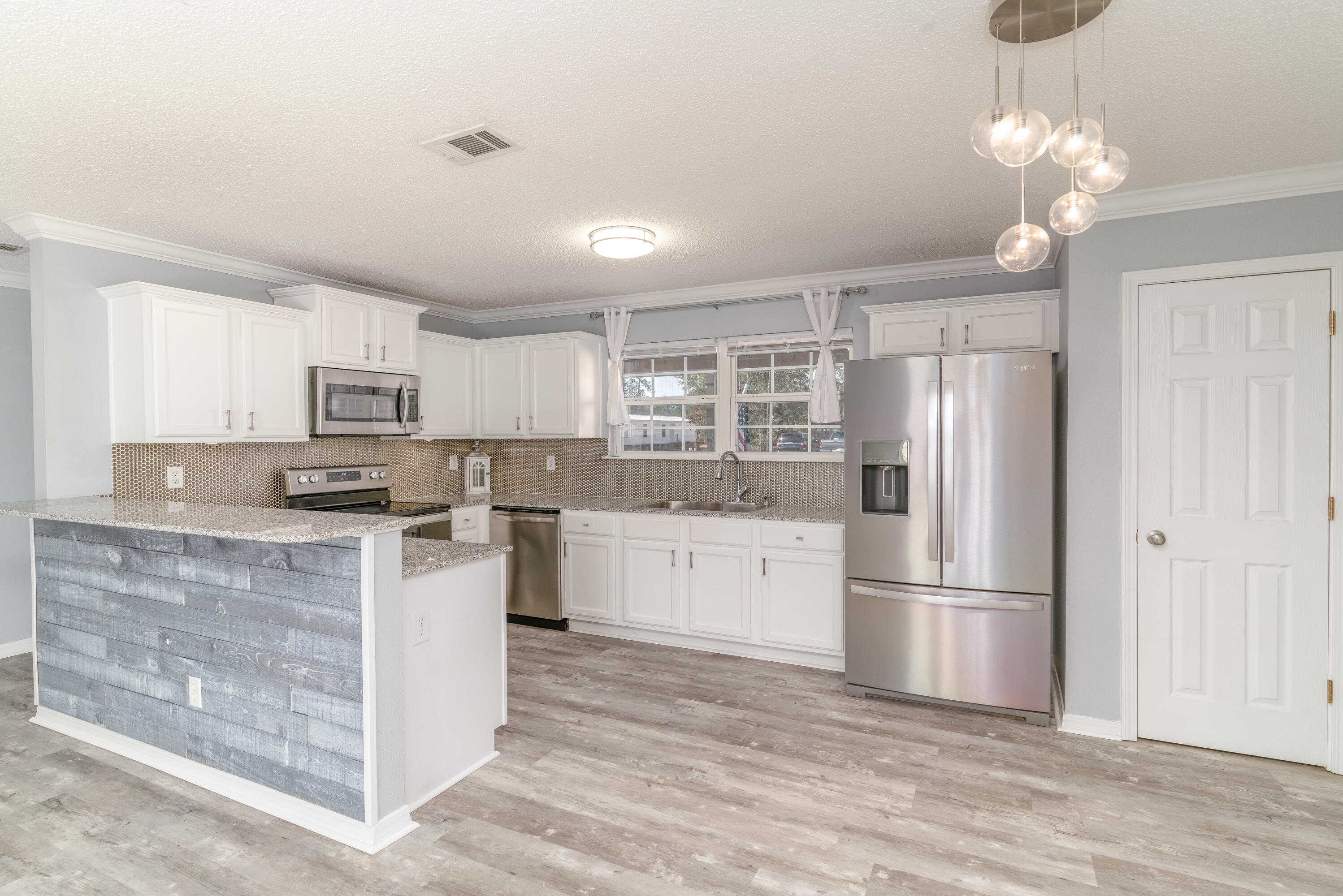 5191 Quince Avenue Crestview, FL 32539 - Photo 8 of 45 a kitchen with kitchen island granite countertop appliances cabinets and a counter space