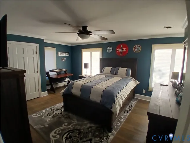 a bedroom with a bed a dresser next to a window