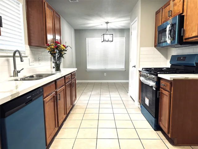 a kitchen with a sink stove and cabinets