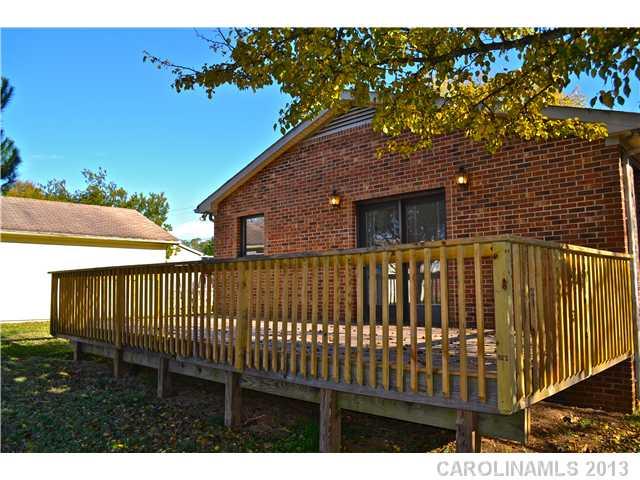 3417 Sandy Porter Road Charlotte, NC 28273 - Photo 5 of 12 a view of a brick house with a small yard