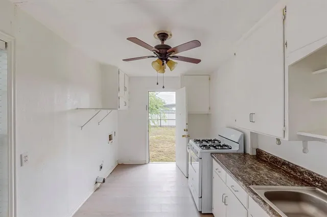 a kitchen with a stove a sink and a refrigerator