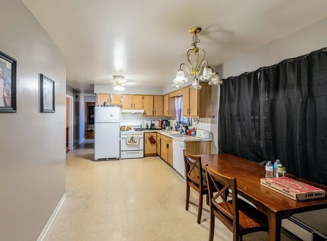a kitchen with refrigerator and cabinets