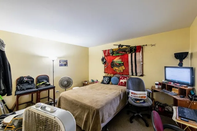 a bedroom with bed and a window