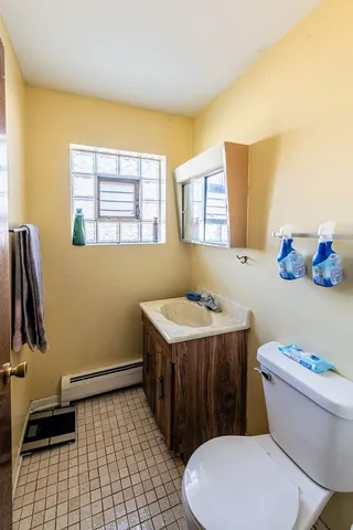 a bathroom with a sink a toilet and a tub