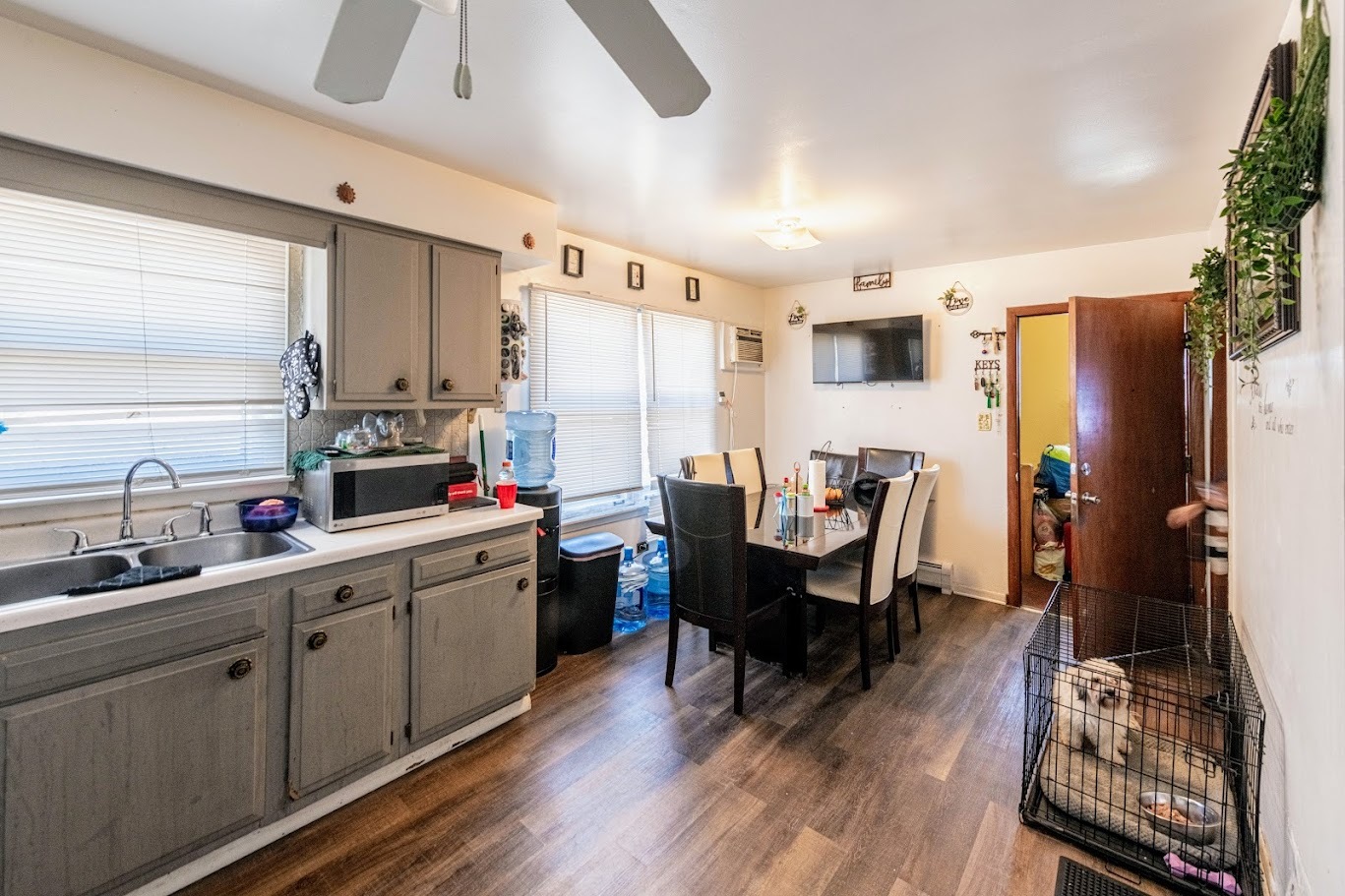 1619 35th Avenue Melrose Park, IL 60160 - Photo 20 of 35 a kitchen with a sink dishwasher a dining table and chairs with wooden floor