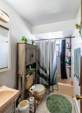 a bathroom with a toilet a sink and a shower